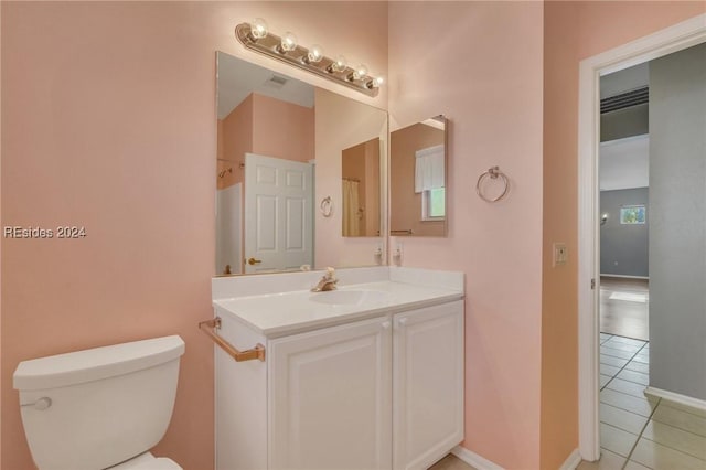 bathroom featuring tile patterned floors, toilet, and vanity