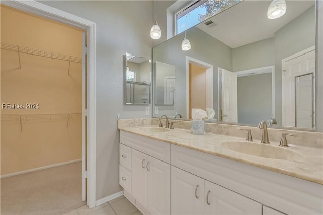 bathroom with tile patterned flooring and vanity