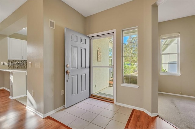 foyer entrance with light tile patterned flooring