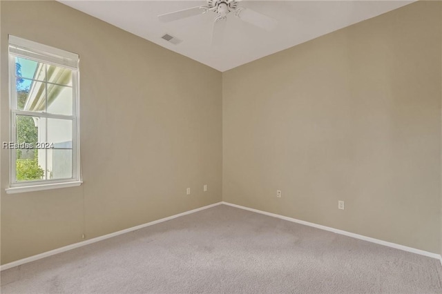 unfurnished room featuring ceiling fan and carpet floors