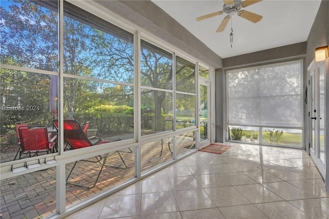 unfurnished sunroom with ceiling fan