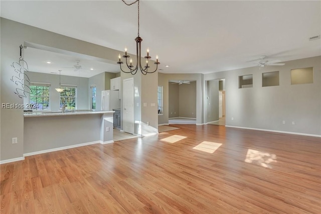 interior space with sink, light hardwood / wood-style floors, and ceiling fan