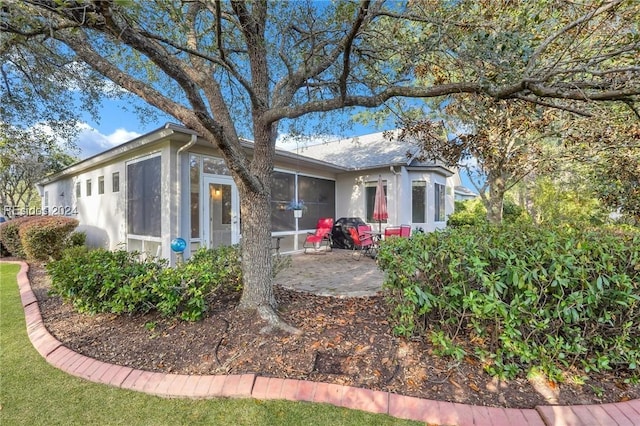 ranch-style house with a sunroom and a patio