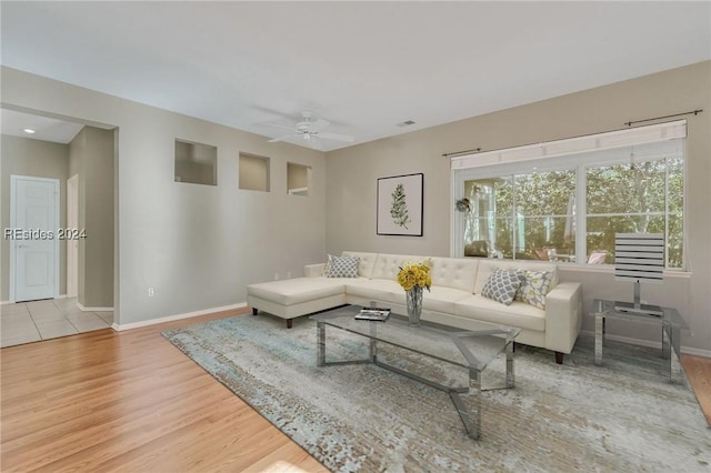 living room with ceiling fan and light hardwood / wood-style floors