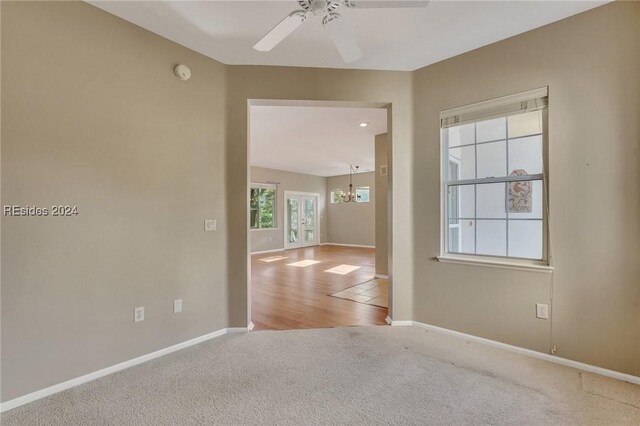 empty room with light colored carpet and ceiling fan