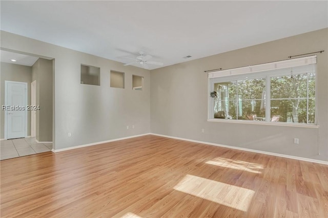 spare room with ceiling fan and light hardwood / wood-style flooring