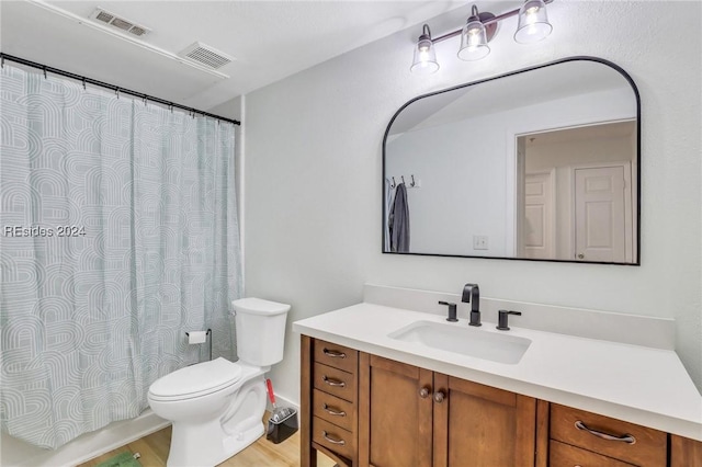 bathroom with vanity, hardwood / wood-style floors, and toilet