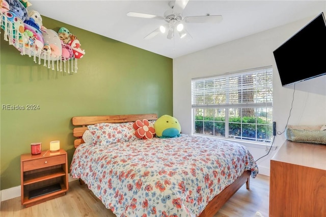 bedroom with ceiling fan and light hardwood / wood-style floors