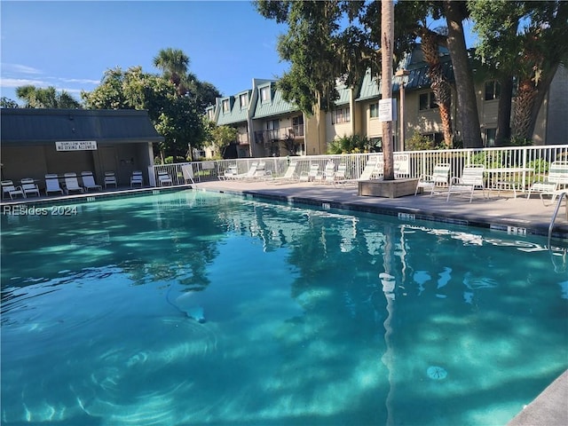 view of swimming pool with a patio area