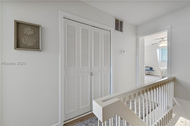 hallway with hardwood / wood-style flooring