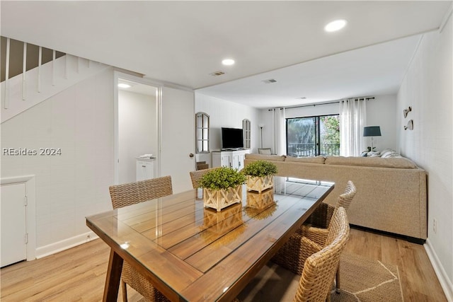 dining space with light hardwood / wood-style flooring