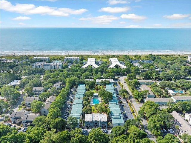 drone / aerial view featuring a beach view and a water view