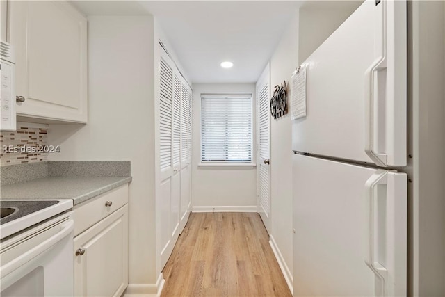 kitchen featuring white appliances, light hardwood / wood-style flooring, decorative backsplash, and white cabinets