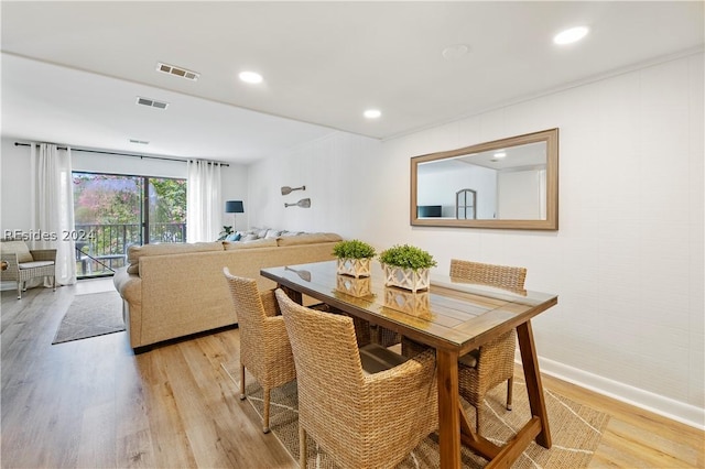 dining space with light hardwood / wood-style flooring