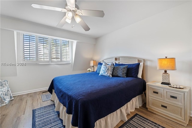 bedroom with light wood-type flooring and ceiling fan