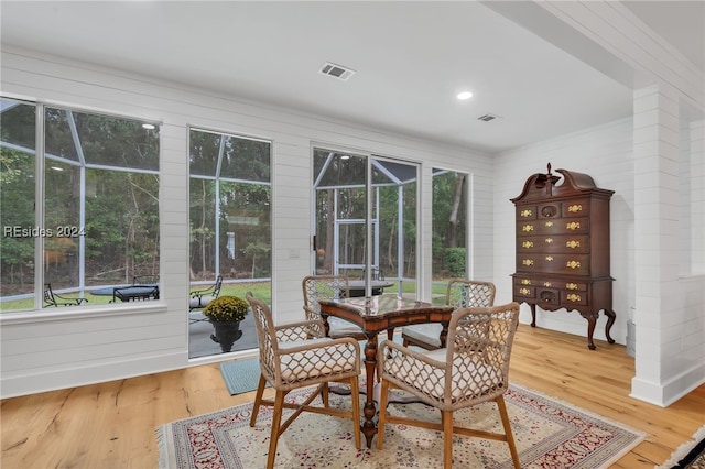 dining space with plenty of natural light and hardwood / wood-style floors