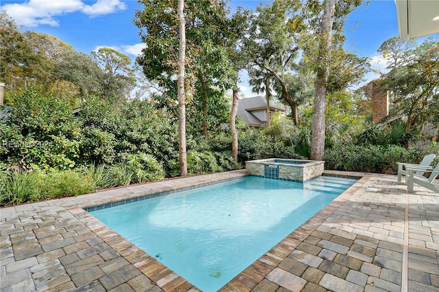 view of swimming pool with a patio and an in ground hot tub