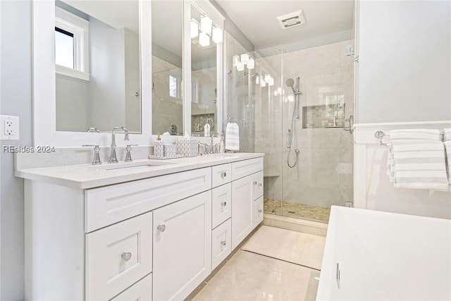 bathroom featuring walk in shower, vanity, and tile patterned flooring