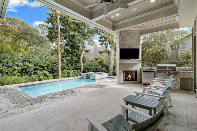 view of pool featuring an outdoor kitchen, a large fireplace, sink, and a patio