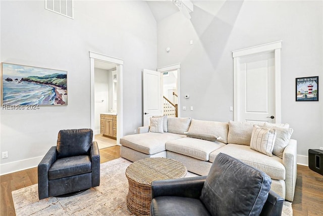 living room featuring hardwood / wood-style floors and a high ceiling