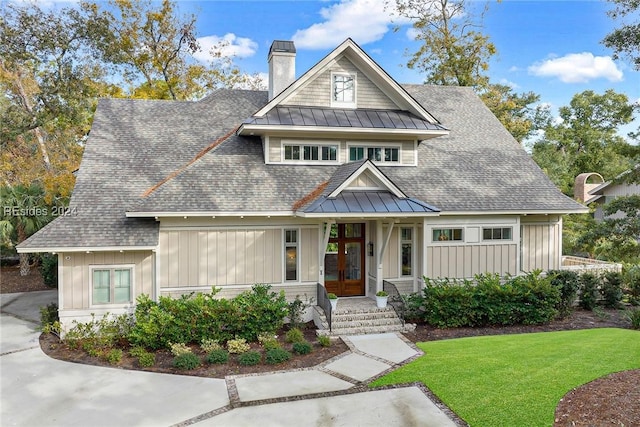 view of front of house with french doors and a front yard