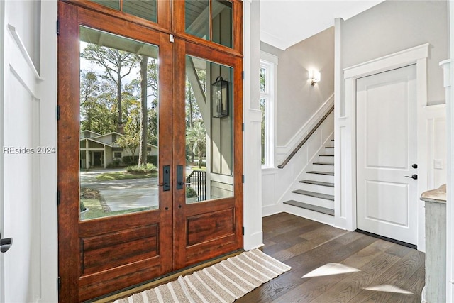 foyer with a healthy amount of sunlight, dark hardwood / wood-style flooring, and french doors