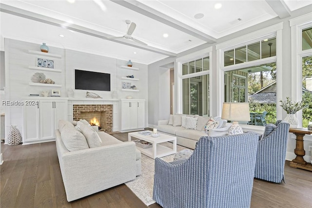 living room featuring a brick fireplace, crown molding, dark wood-type flooring, and beamed ceiling