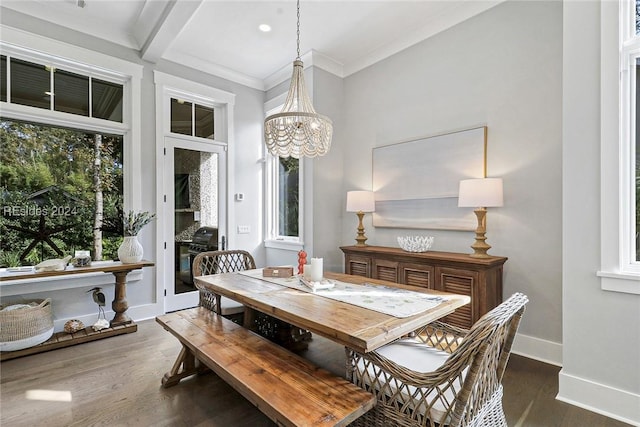 dining room with ornamental molding, dark hardwood / wood-style floors, and a notable chandelier