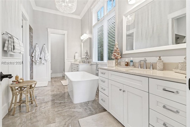 bathroom featuring a tub, ornamental molding, vanity, a notable chandelier, and toilet