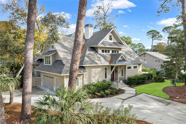 view of front of home featuring a garage and a front yard