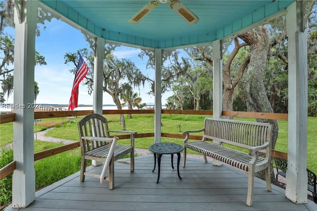 exterior space with ceiling fan and a yard