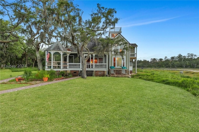 view of front of property with a gazebo and a front lawn