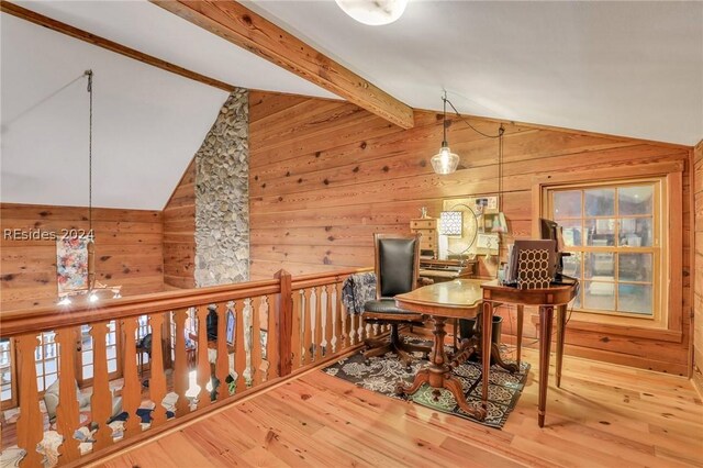 office area with vaulted ceiling with beams, wood walls, and light wood-type flooring