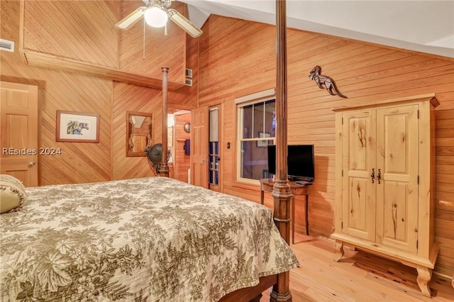 bedroom featuring beamed ceiling, ceiling fan, light hardwood / wood-style floors, and wood walls