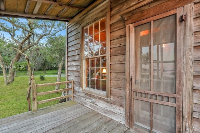 wooden deck with a lawn