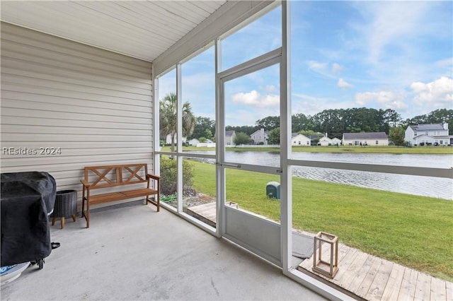 sunroom / solarium with a water view