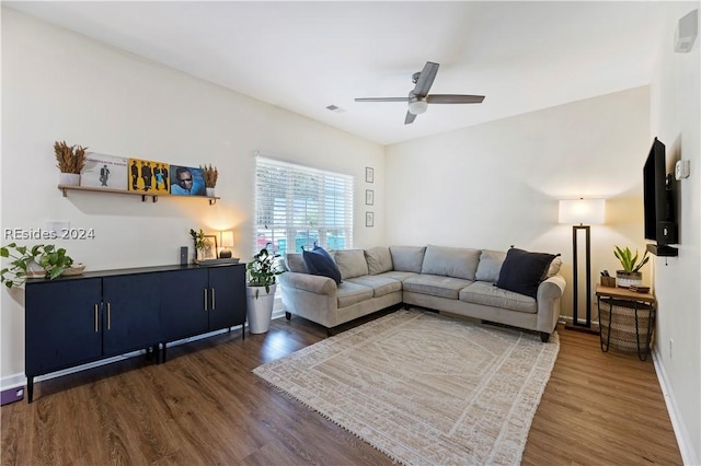 living room with ceiling fan and dark hardwood / wood-style flooring