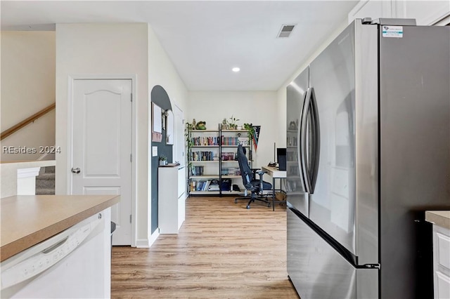 kitchen with stainless steel refrigerator, dishwasher, light hardwood / wood-style floors, and white cabinets