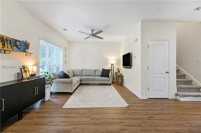 living room with dark hardwood / wood-style floors and ceiling fan