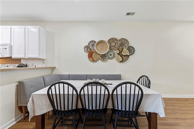 dining room featuring light wood-type flooring and breakfast area