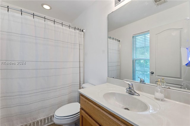 bathroom with vanity and toilet