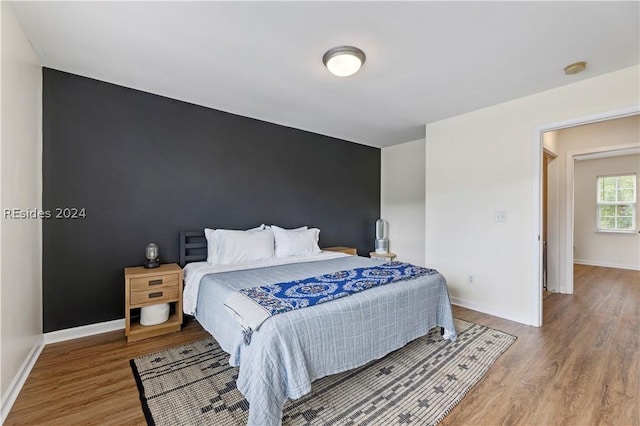 bedroom with hardwood / wood-style floors