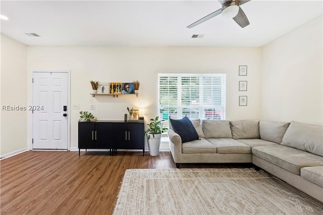 living room with ceiling fan and dark hardwood / wood-style floors