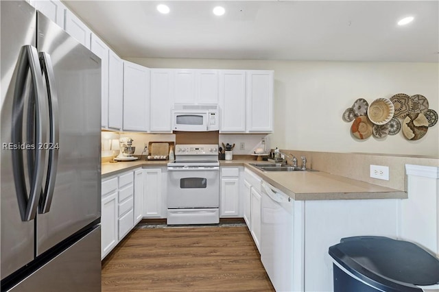 kitchen featuring white cabinetry, sink, white appliances, and dark hardwood / wood-style floors