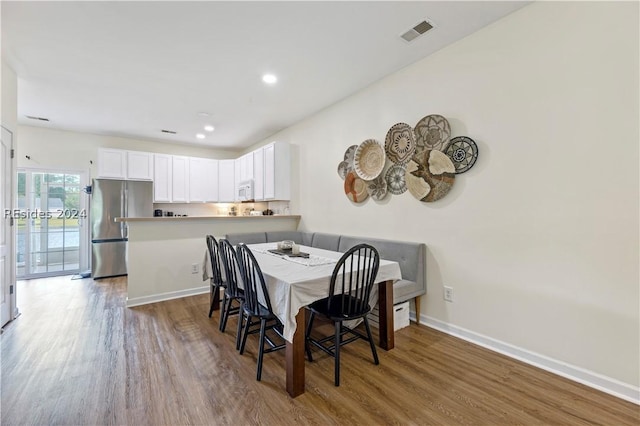 dining room with hardwood / wood-style floors