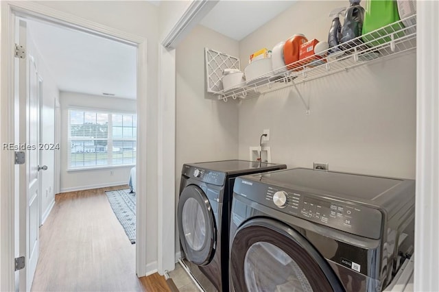 washroom featuring hardwood / wood-style flooring and independent washer and dryer