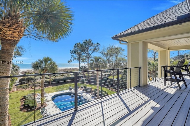 deck with a fenced in pool and a water view