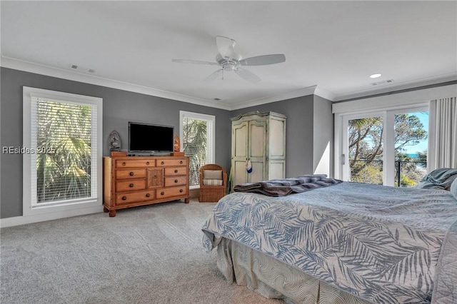 bedroom featuring multiple windows, ornamental molding, light colored carpet, and ceiling fan