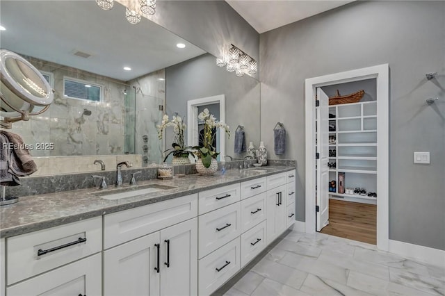 bathroom featuring vanity and a shower with door