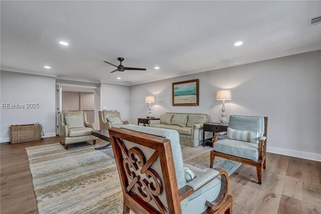 living room with ceiling fan and light wood-type flooring